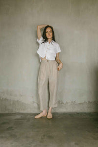Lightweight button down with a short sleeve in white linen paired with natural linen pants